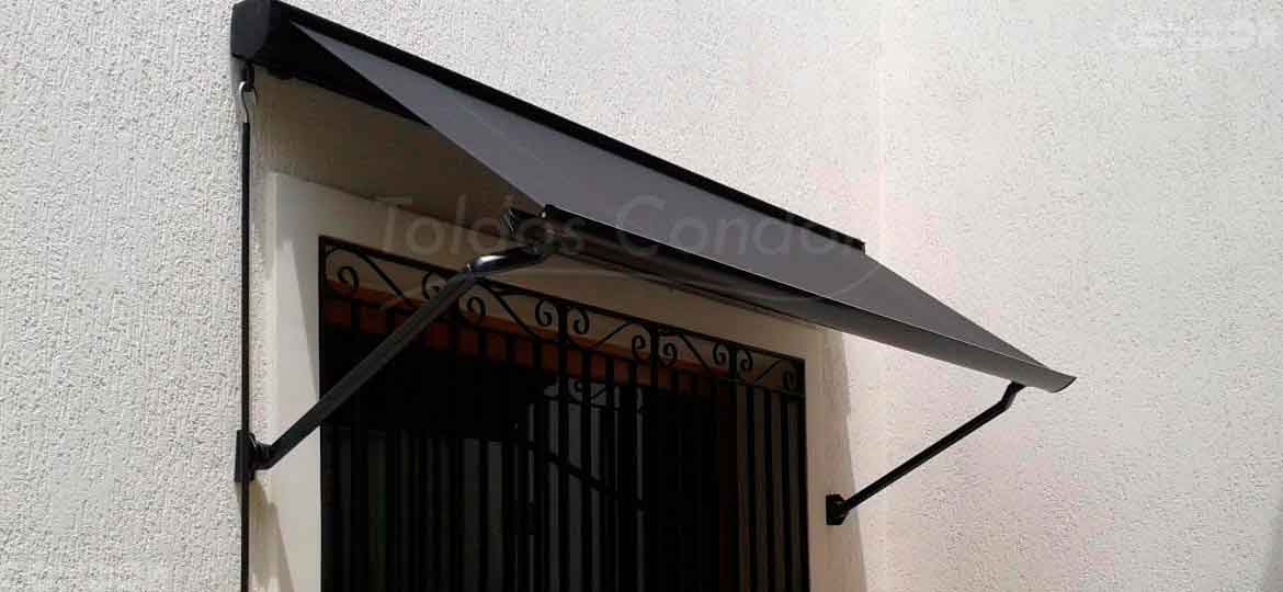 toldo retratil aberto protegendo uma janela com grades